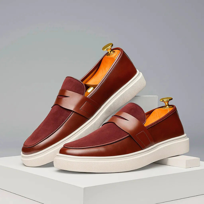 Men's penny loafers showing the flat rubber sole and round toe construction