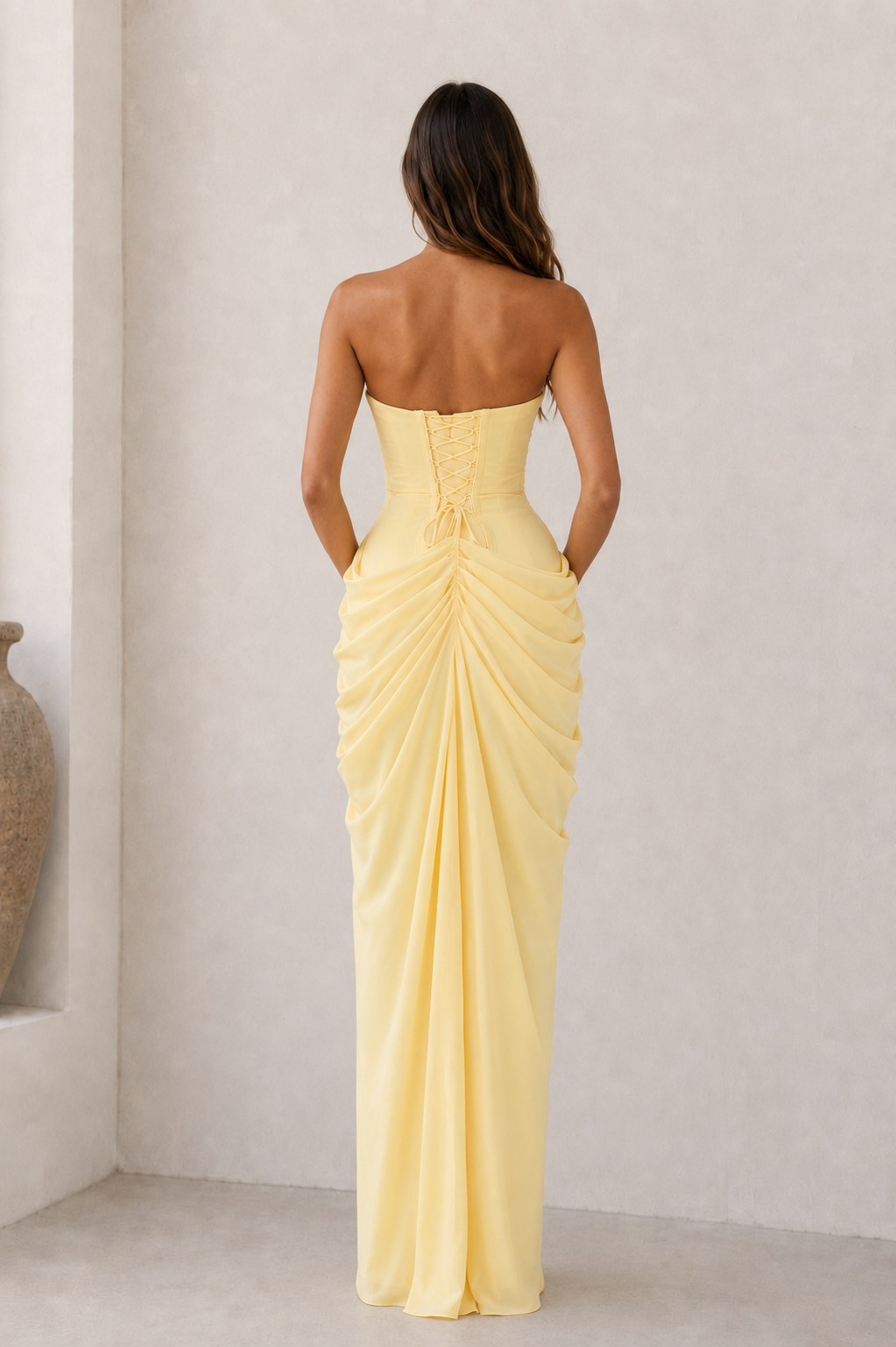 Strapless draped maxi dress with concealed side closure and maxi-length flowing skirt