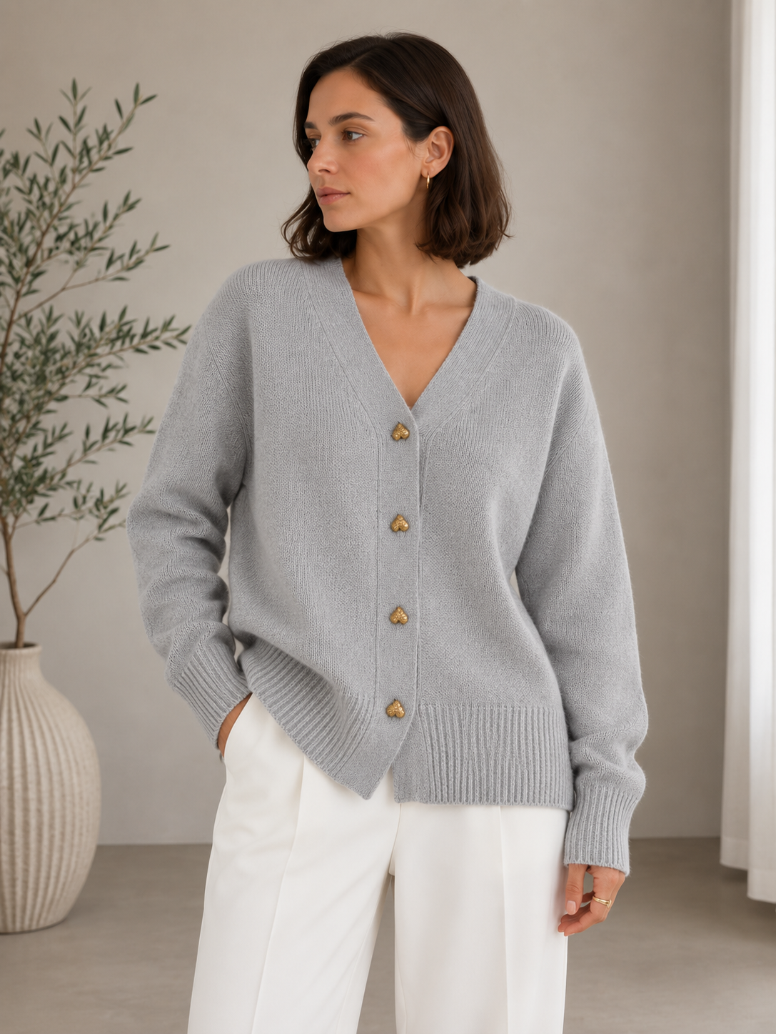 Women's knitted cardigan with ribbed edges and decorative button front, styled view