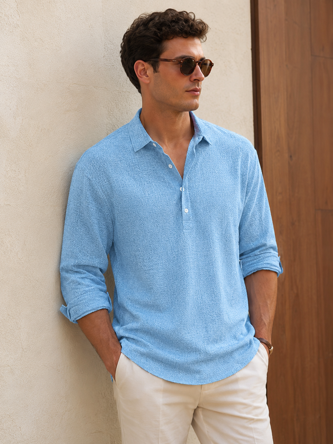 Men's textured fabric shirt with partial button placket, classic collar, long sleeves, and rounded hem