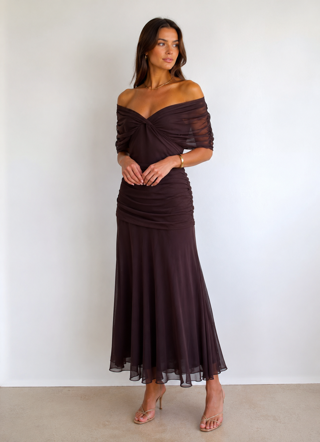 Off-shoulder maxi dress with twisted front draping and flowing skirt