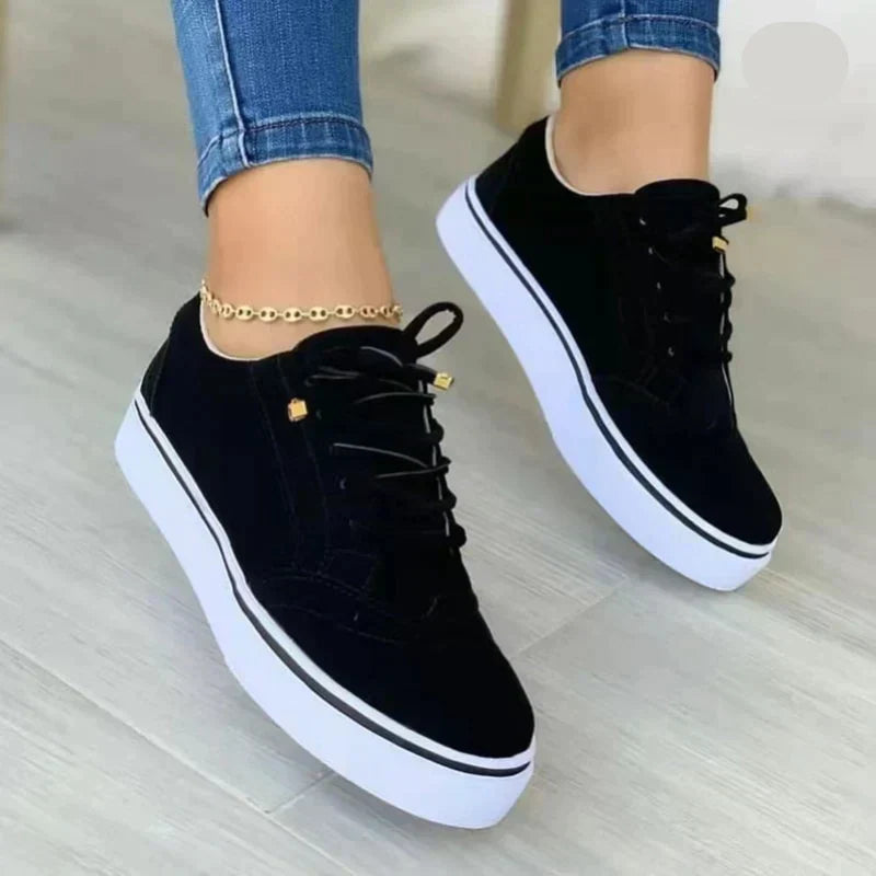 Women's low-silhouette lace-up sneakers with stitched panels and flat rubber platform sole