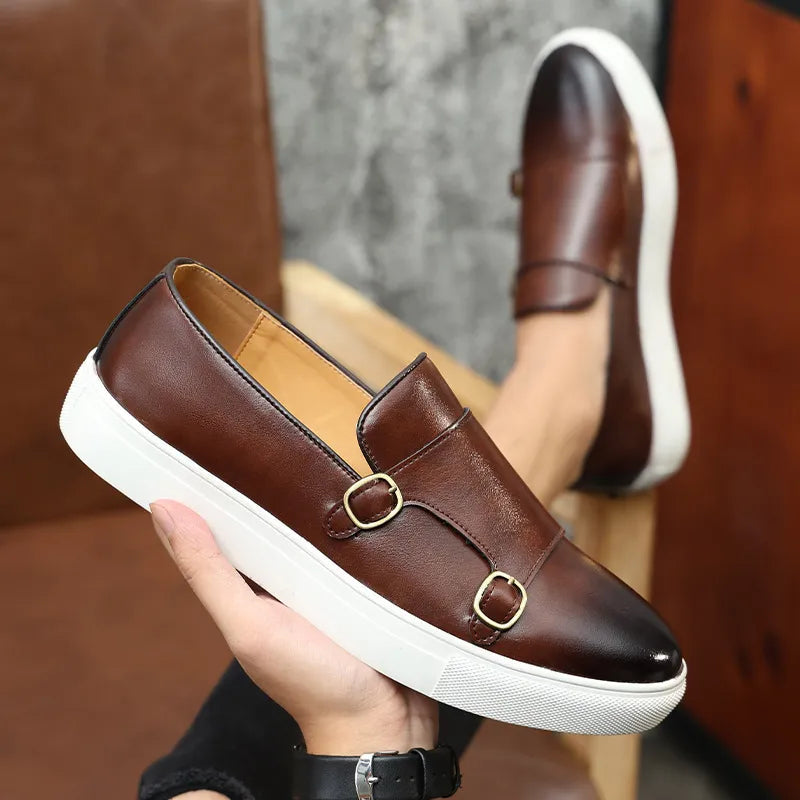 Men's slip-on dress shoes with dual buckle straps, round toe, and flat rubber sole