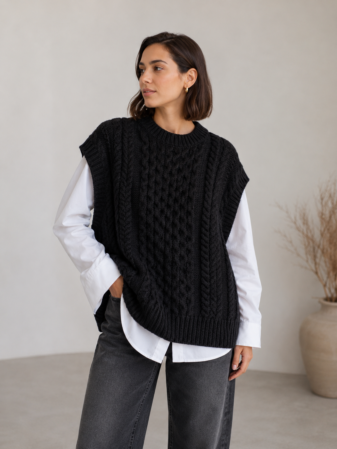 Cable knit sleeveless sweater for women showing back panel and structured knit texture