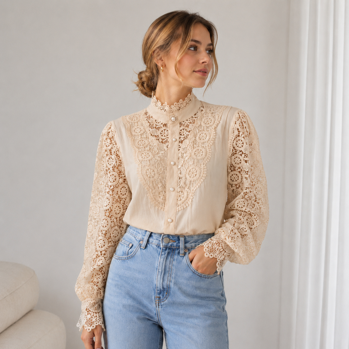 Close-up of lace fabric texture on a women's long-sleeve blouse with high collar