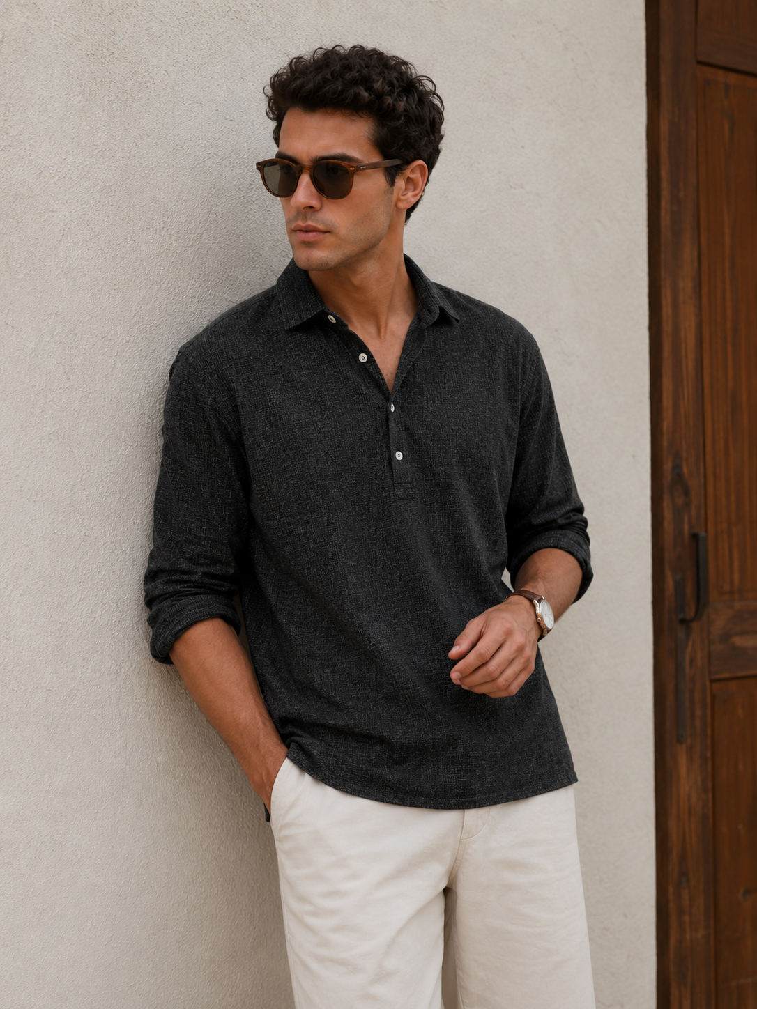 Men's button-placket shirt in textured fabric with classic collar, adjustable cuffs, and hip-length rounded hem