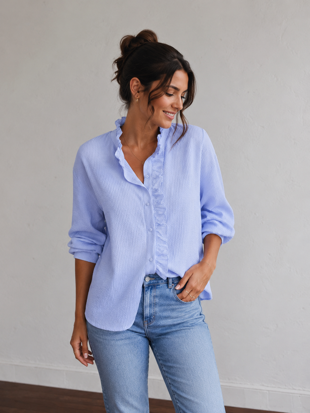 Women's textured blouse with ruffle trim along the V-neck and front edge