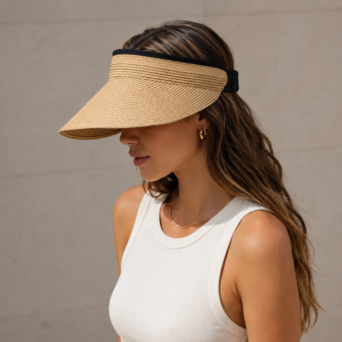 Women's woven sun visor with wide curved brim and open top, adjustable back band