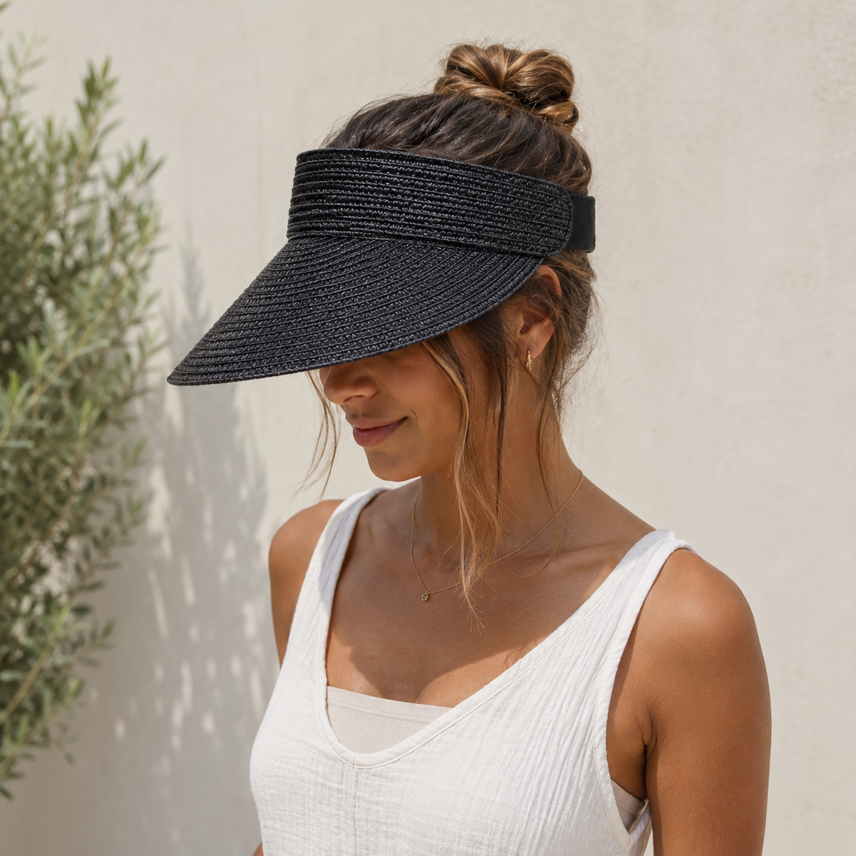 Woven sun visor with structured curved brim and open crown, adjustable fit