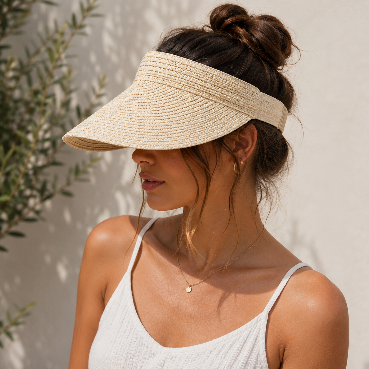 Women's sun visor with wide woven brim and open-top design, adjustable back closure