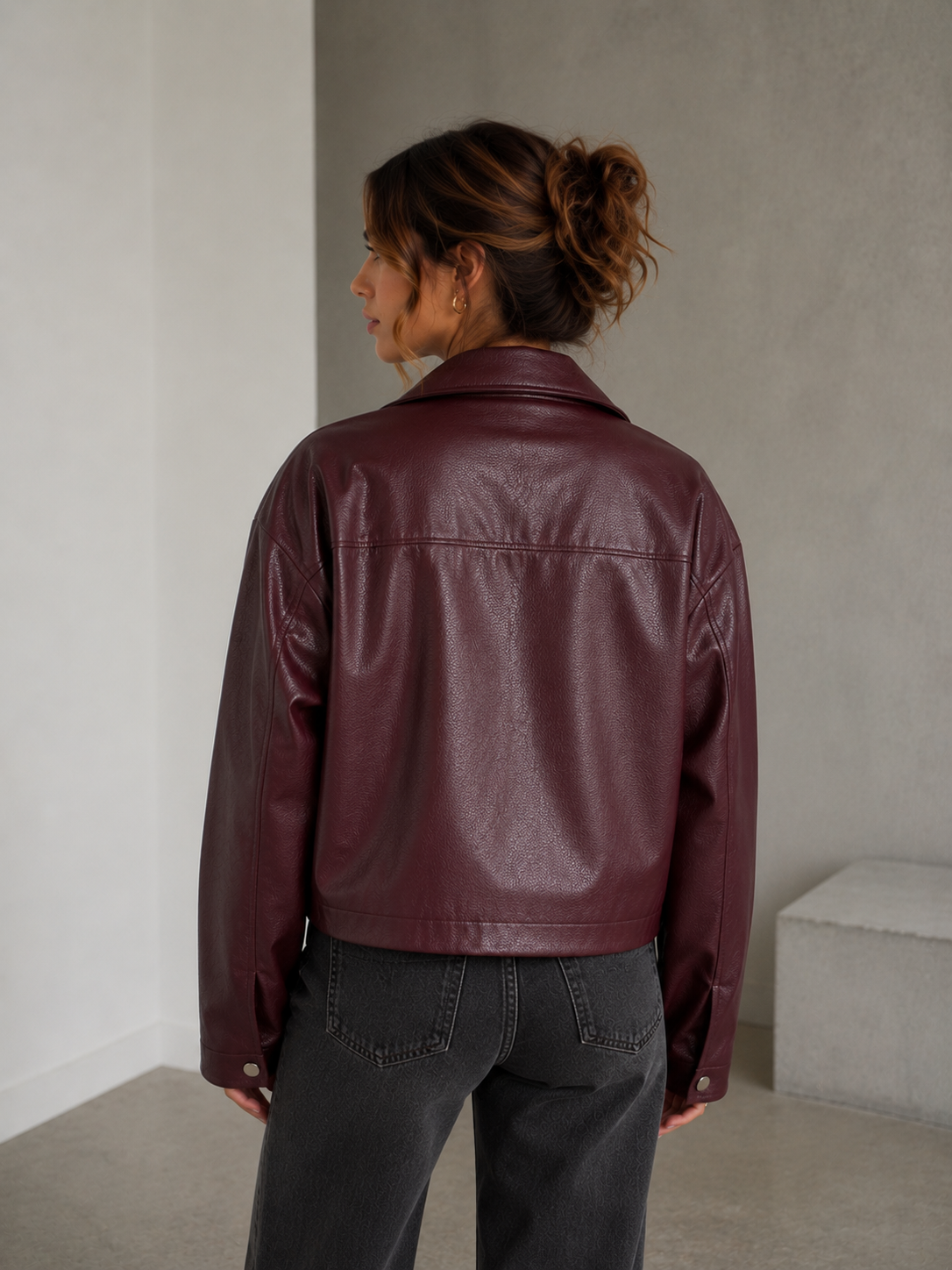 Straight-fit women's faux leather jacket with smooth surface and zipper closure