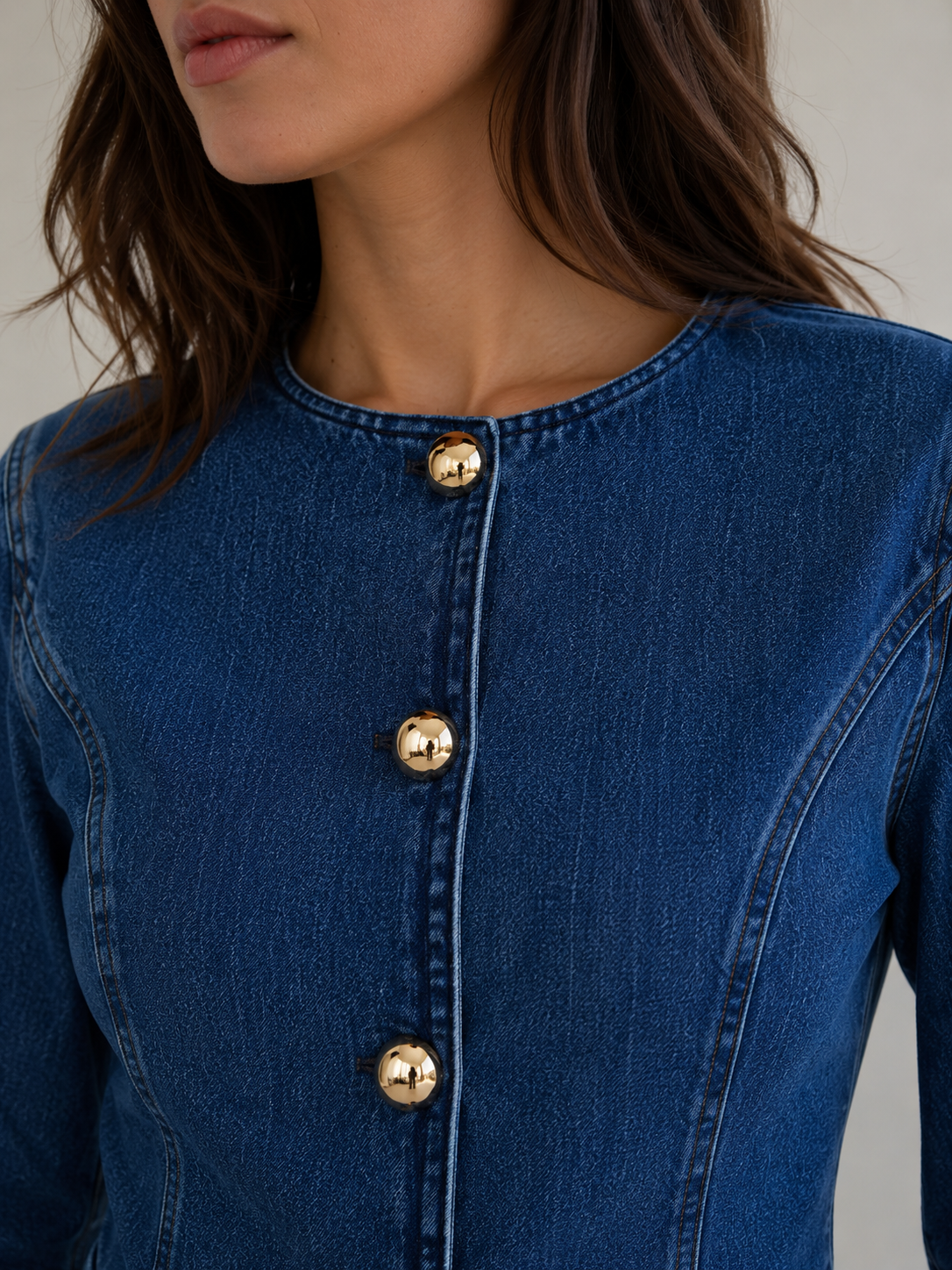 Women's structured denim jacket with marked seams and button front detail