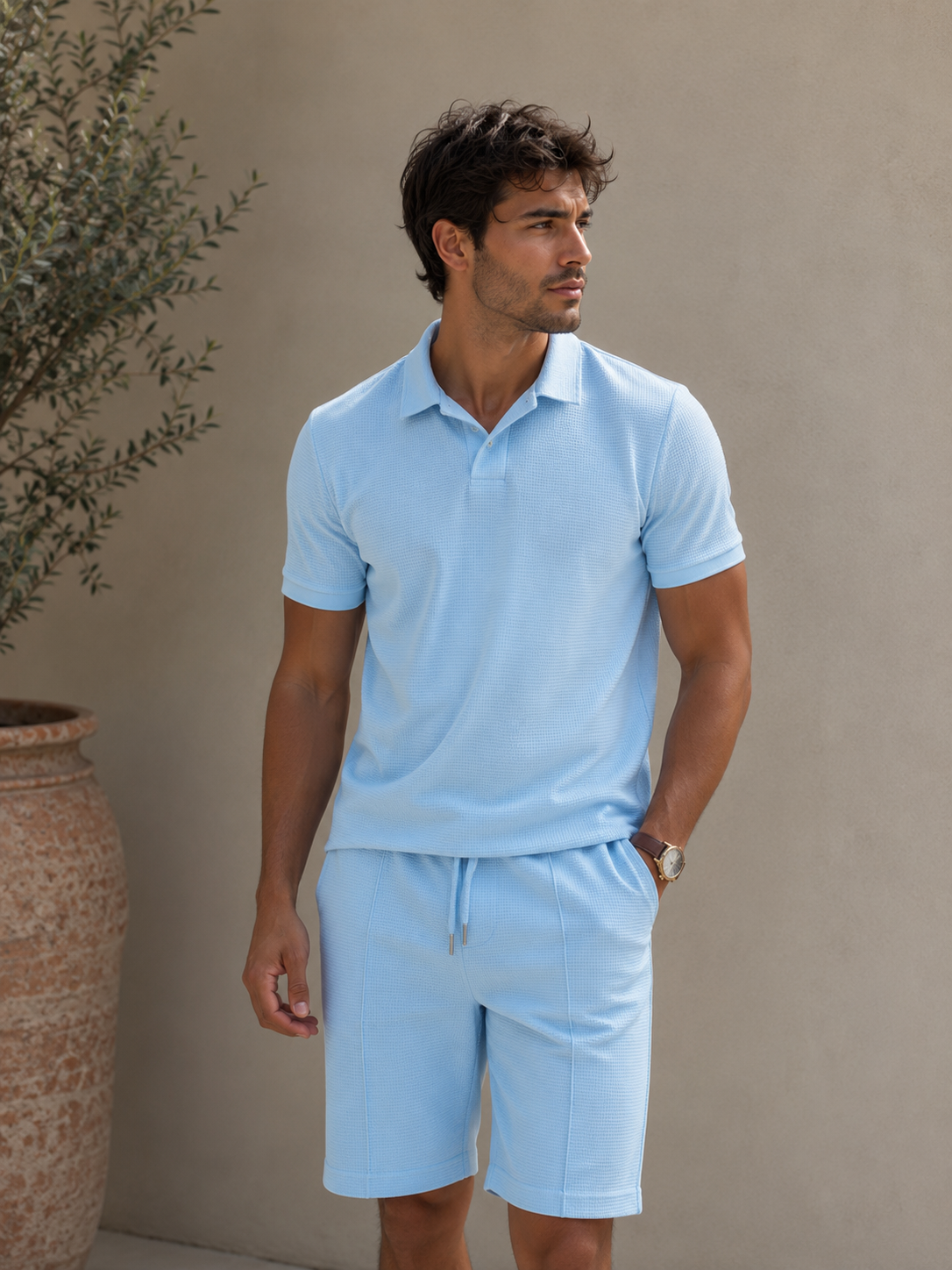 Men's textured polo shirt and shorts set in a soft baby blue with open collar and drawstring shorts