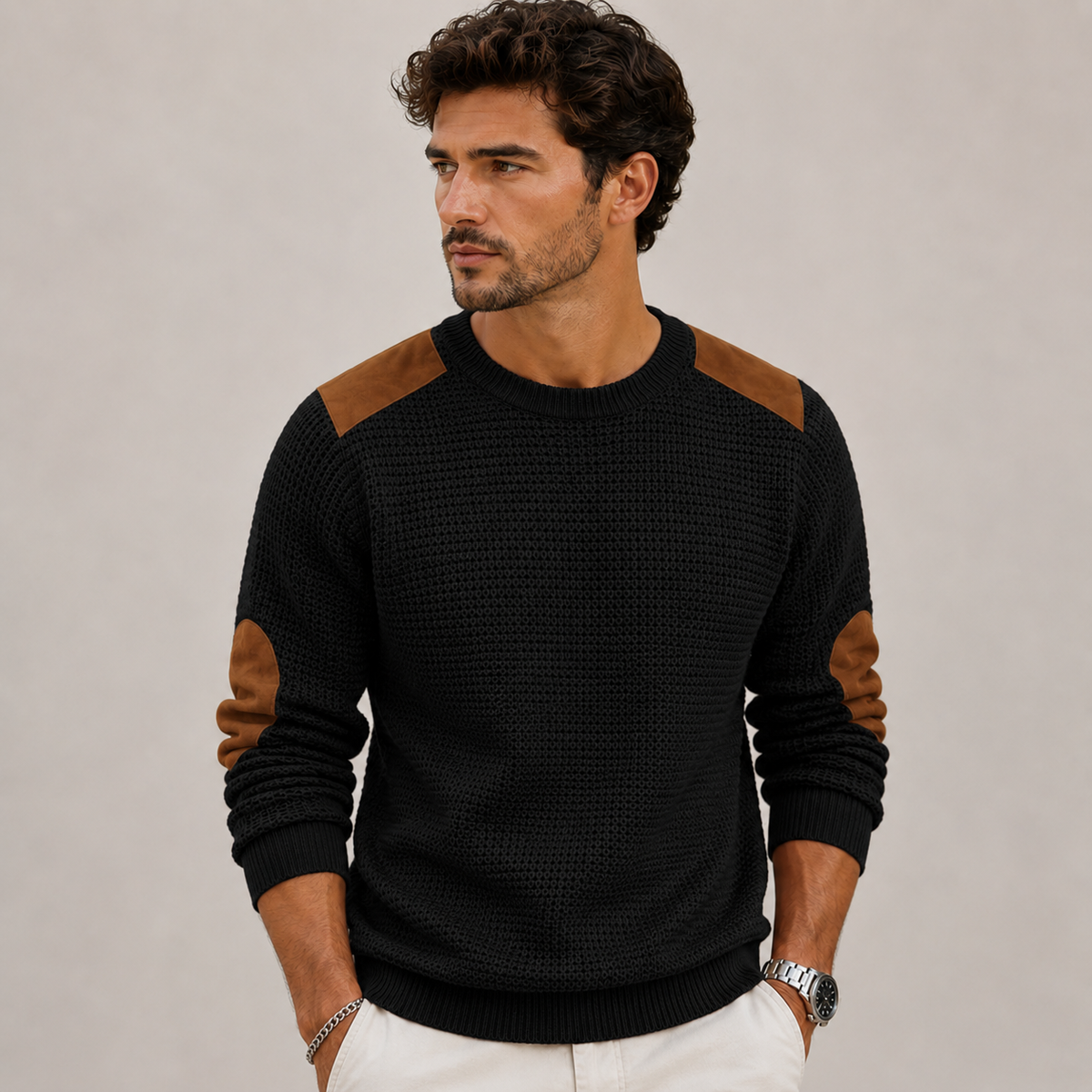 Close-up of men's crew neck knit sweater with structured shoulder and elbow detailing