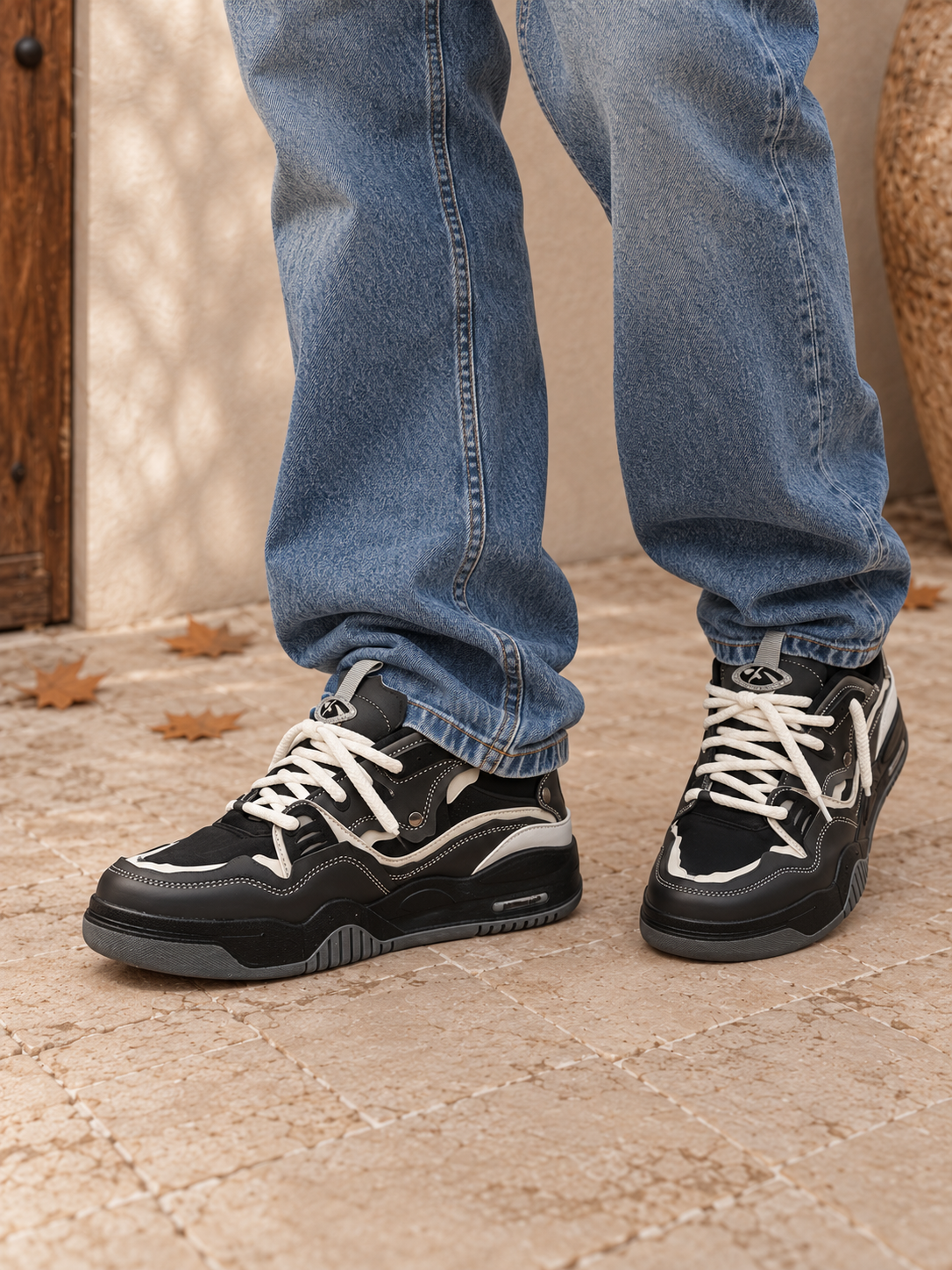 Men's low-profile sneakers with chunky molded sole, lace-up closure, padded collar, and panel construction with contrast stitching