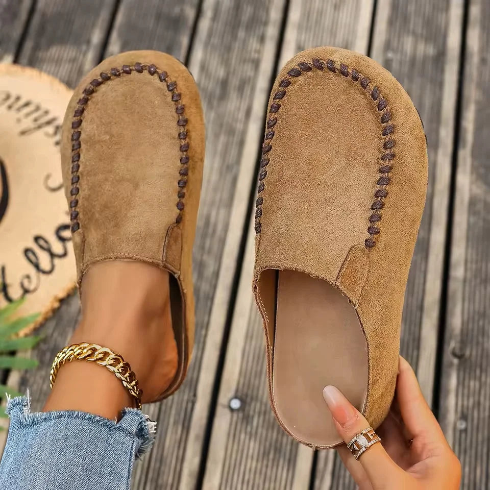 Women's suede slip-on clogs with round closed toe and open heel, flat sole