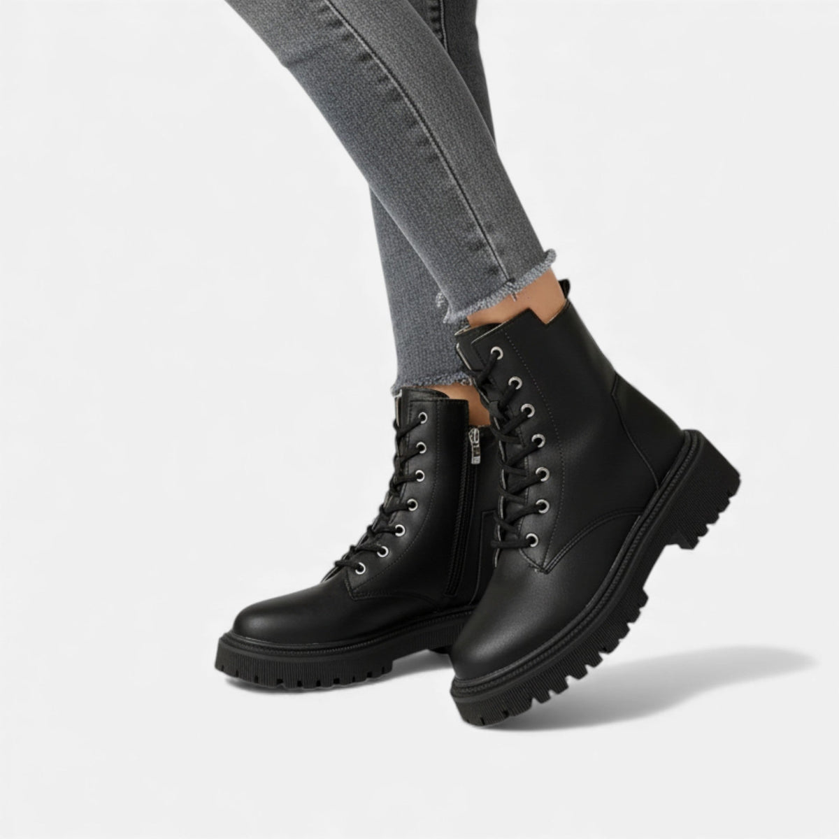 Women's ankle boots featuring front lacing, structured synthetic upper, and rear pull tab