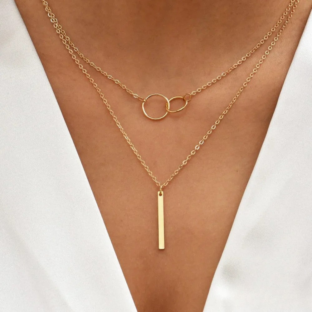 Women's layered chain necklace with minimalist pendants, front view