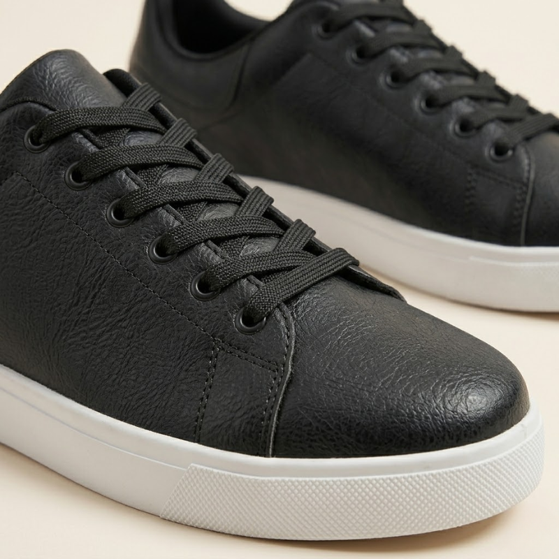 Men's casual leather sneaker featuring lace-up closure and structured silhouette