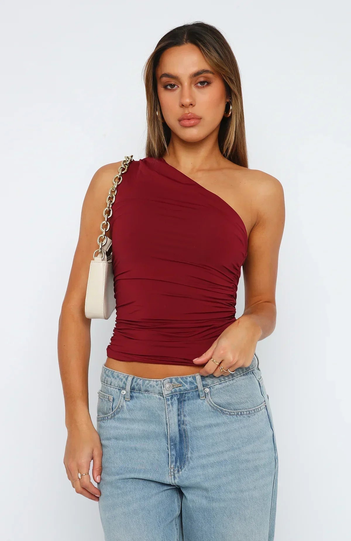 Women's one-shoulder ruched top with asymmetrical neckline and fitted silhouette
