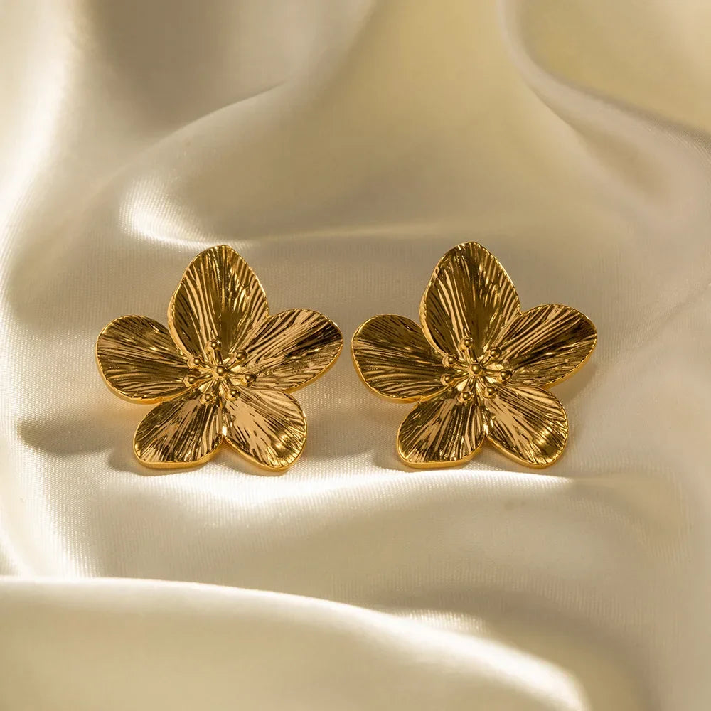 Flower-shaped stud earrings with sculpted gold-colored metal petals