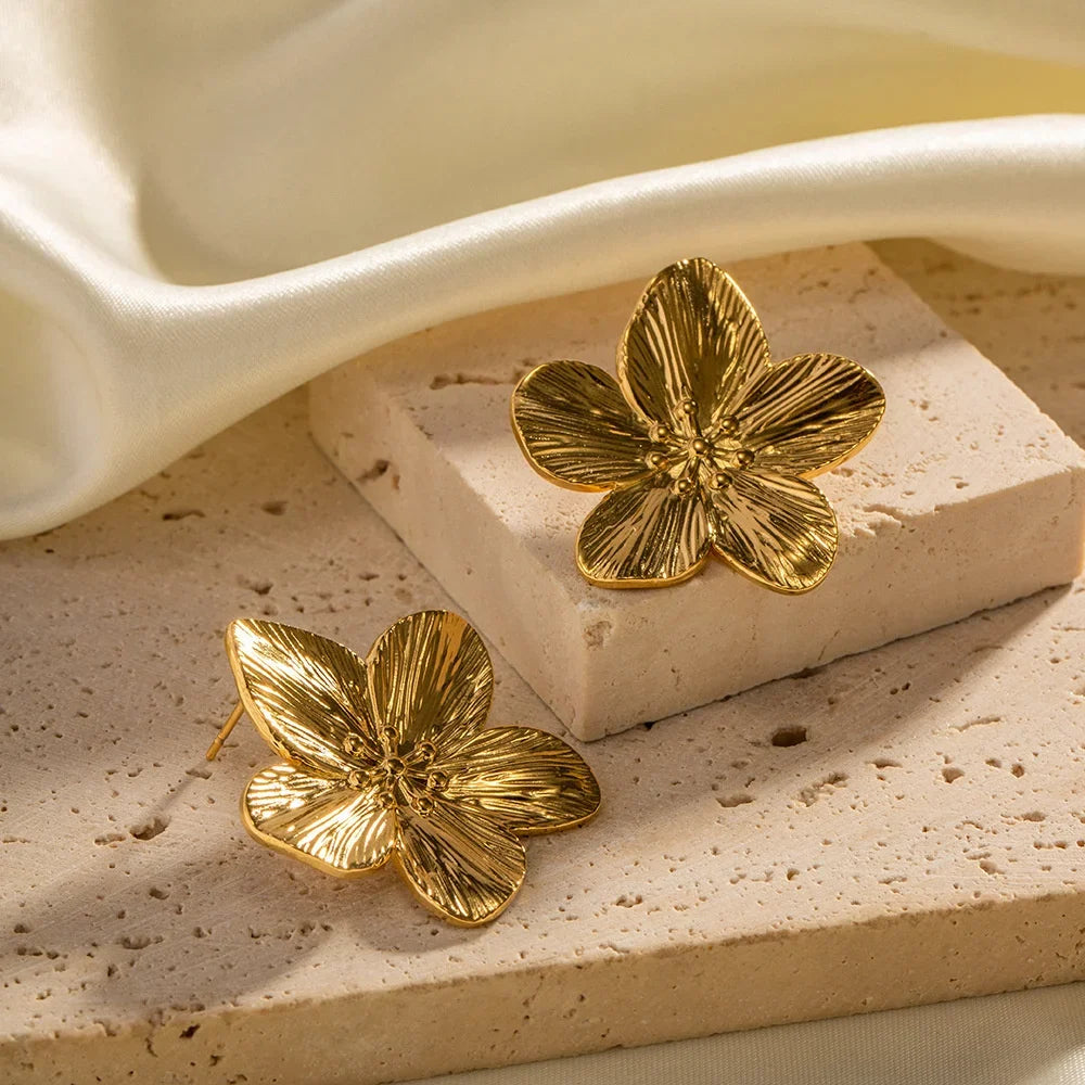 Floral metal stud earrings with gold-colored finish and petal design