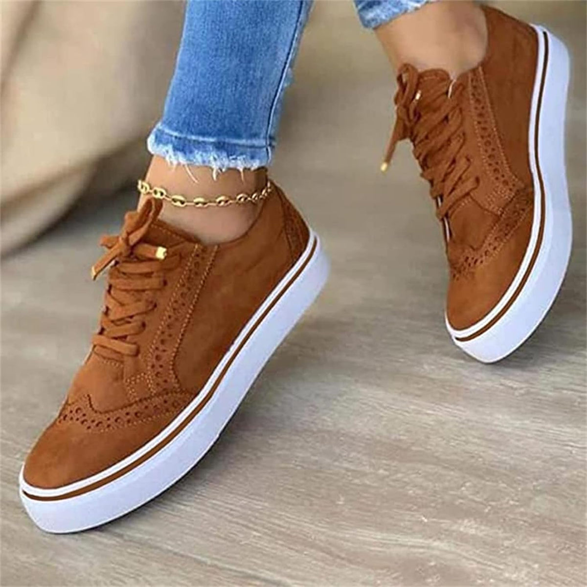 Women's lace-up sneakers with suede-like upper, perforated detailing, and rubber platform sole