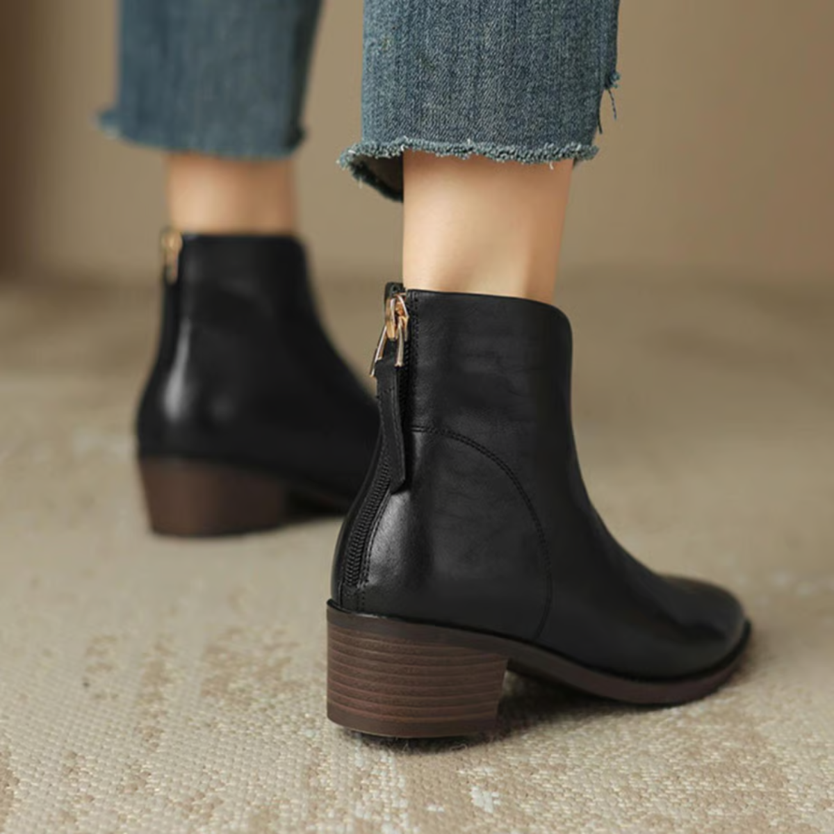 Women's leather ankle boots with block heel worn with tailored trousers