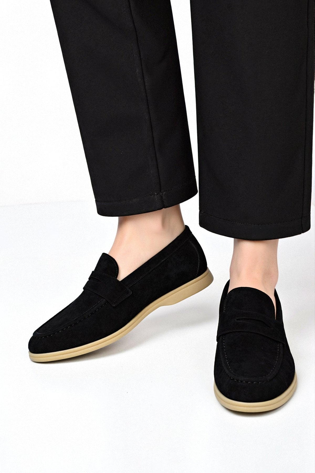 Men's synthetic suede loafers showing flat sole construction and slip-on silhouette