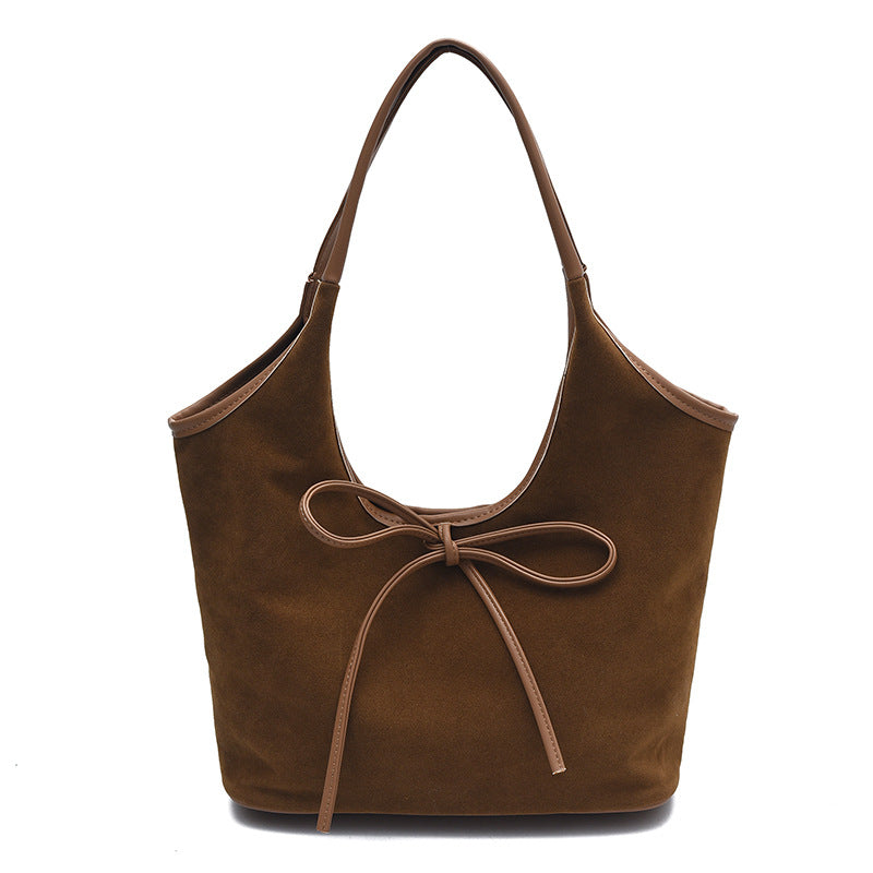 Faux suede women's tote bag featuring a soft structured shape and bow detail