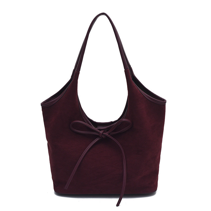 Women's suede tote bag with spacious open-top interior and comfortable shoulder straps