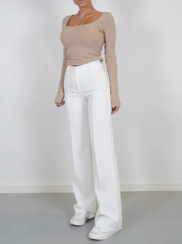 Pantalon taille haute à coupe ample, tissu lisse structuré, silhouette féminine