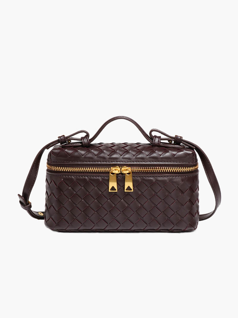 Side profile of women's woven shoulder bag showing structured shape and strap