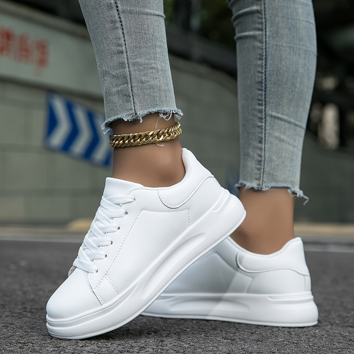 Women's low-profile sneakers with smooth synthetic leather upper and structured silhouette