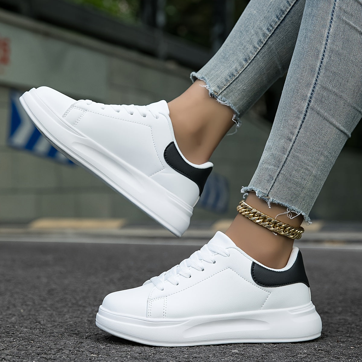 Side profile view of women's synthetic leather sneakers with flat synthetic sole