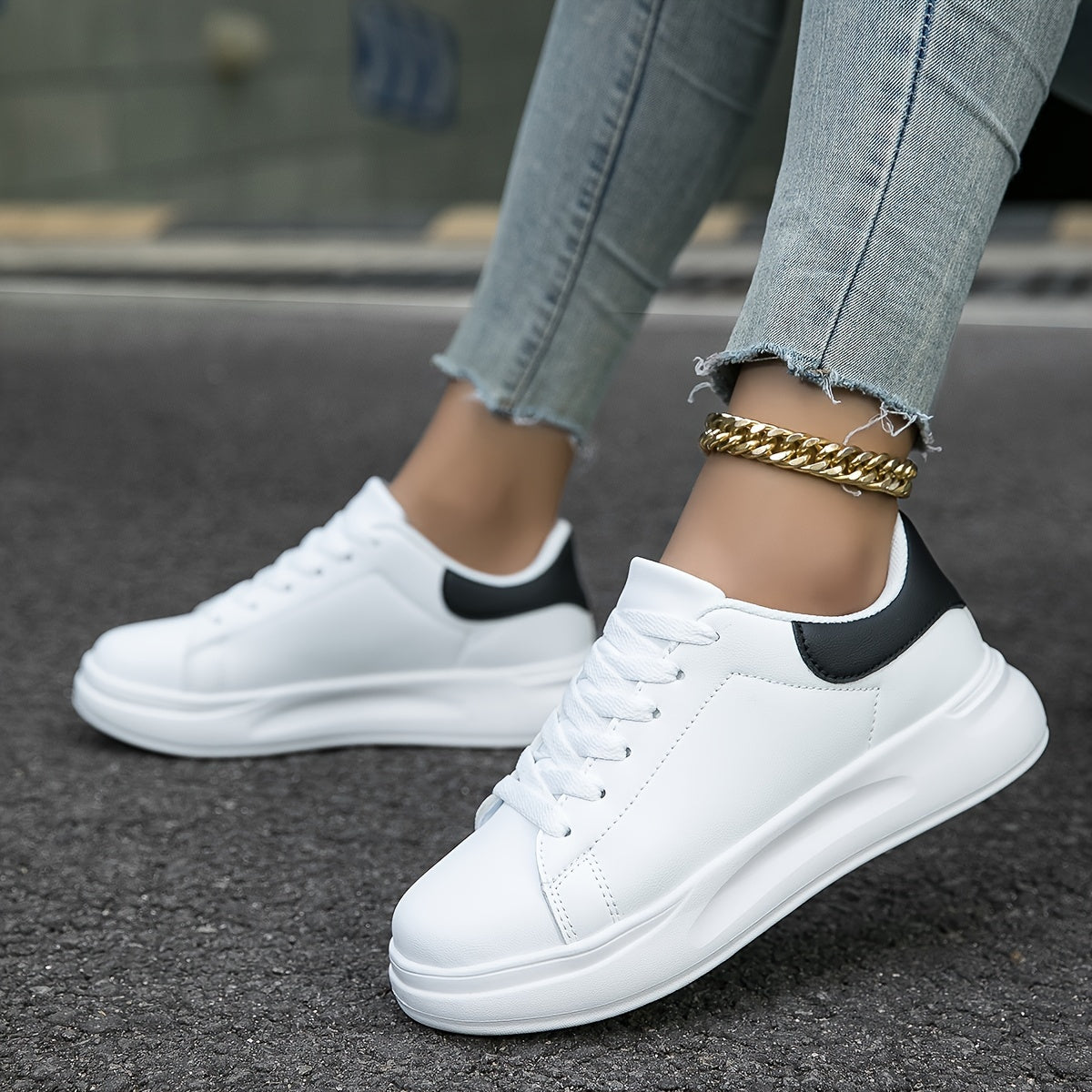 Top-down view of women's synthetic leather sneakers with lace-up front detail
