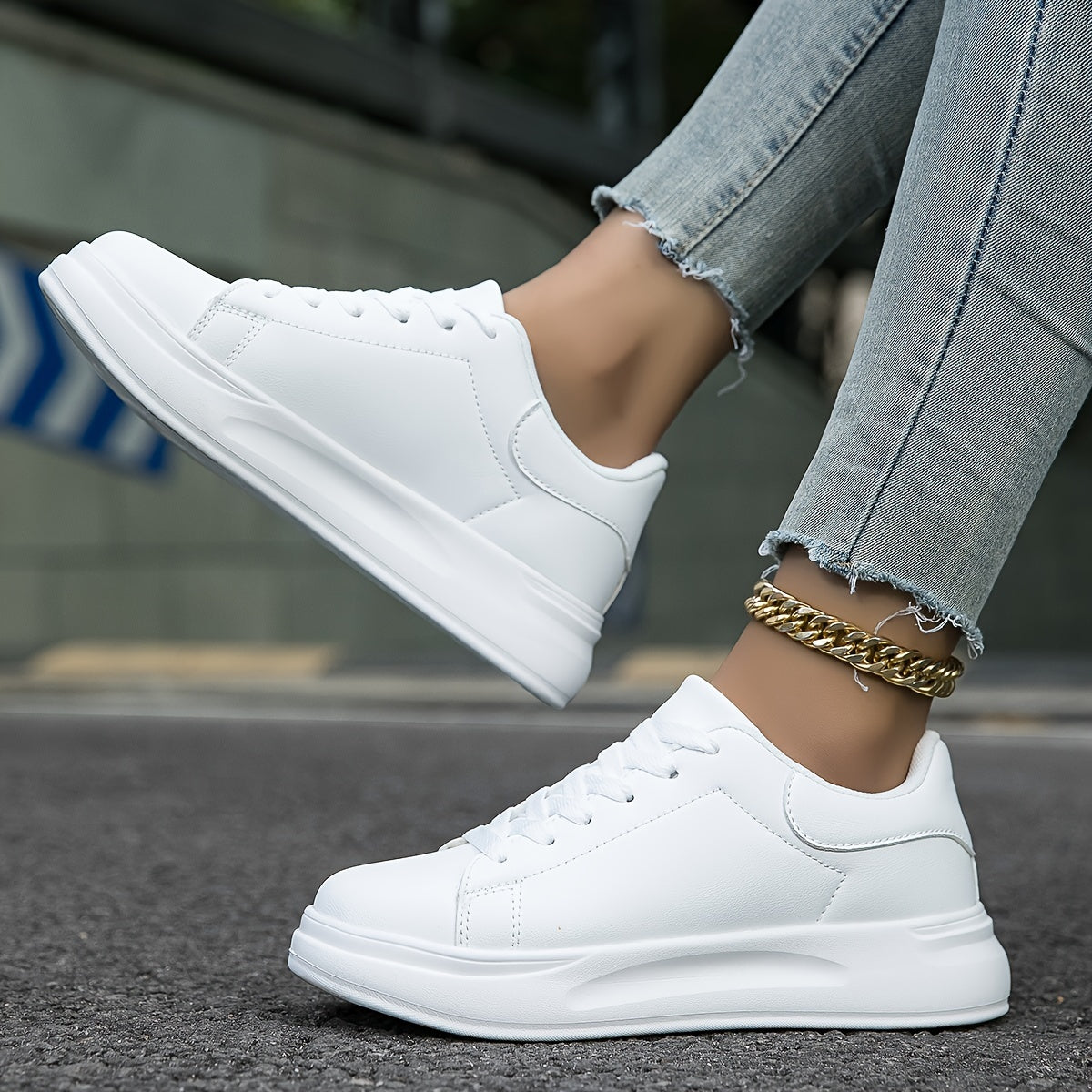 Pair of women's synthetic leather sneakers displayed flat, showing overall silhouette
