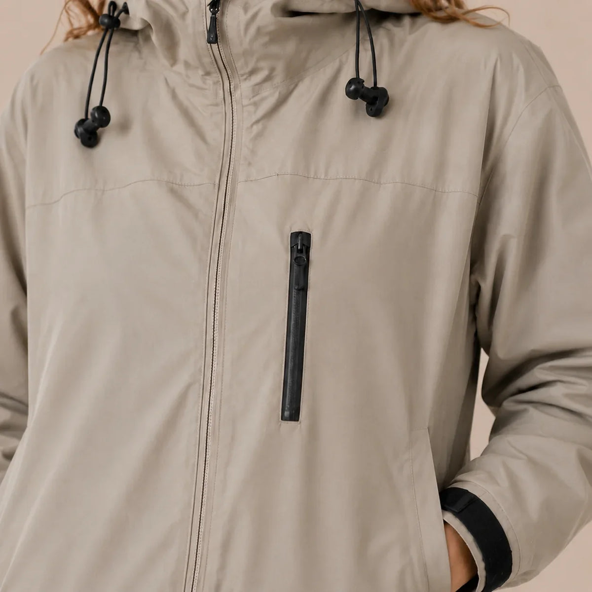 Close-up of women's Khaki raincoat zipper and hood